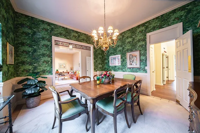 a dining room with furniture a chandelier and window