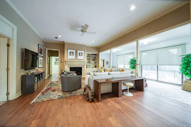 a living room with furniture a fireplace and a flat screen tv