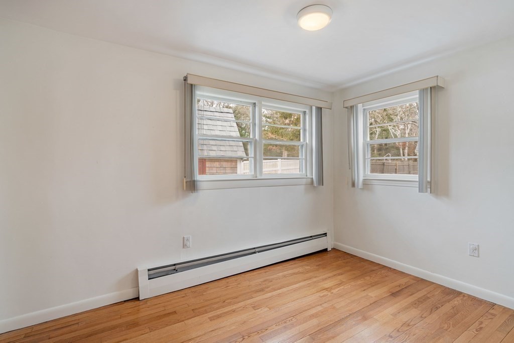 21 Fishermans Cove Road Wareham, MA 02532 - Photo 17 of 34 an empty room with wooden floor and windows