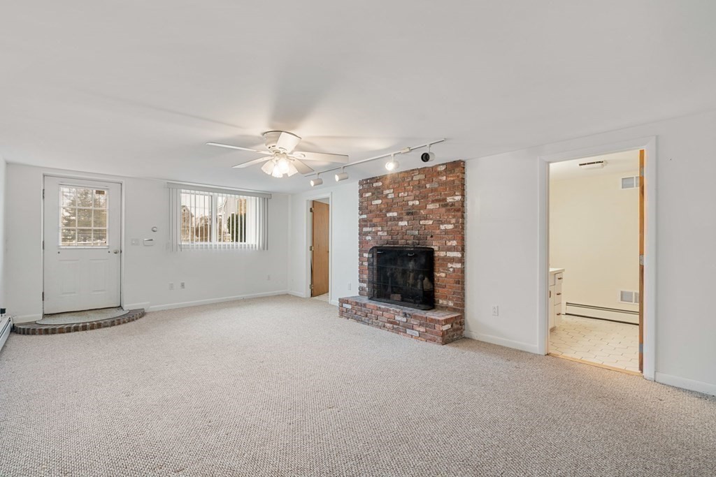 21 Fishermans Cove Road Wareham, MA 02532 - Photo 19 of 34 an empty room with windows and fireplace