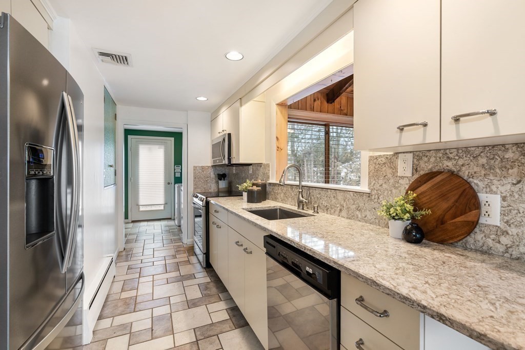 21 Fishermans Cove Road Wareham, MA 02532 - Photo 8 of 34 a kitchen with granite countertop a sink stove and refrigerator