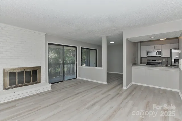 a view of a kitchen with a sink and a stove top oven