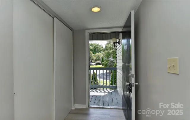 a view of an entryway with wooden floor