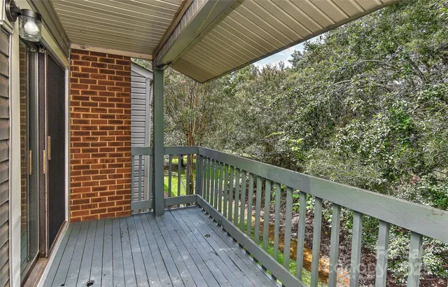 a view of balcony with wooden floor