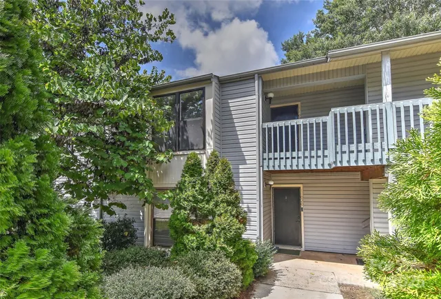 a front view of a house with plants