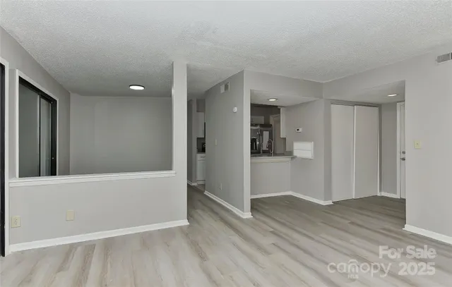 a view of hallway with wooden floor