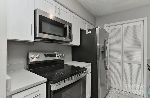 a kitchen with a stove and a microwave