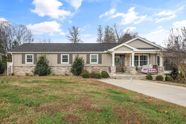 a front view of a house with yard porch and outdoor seating