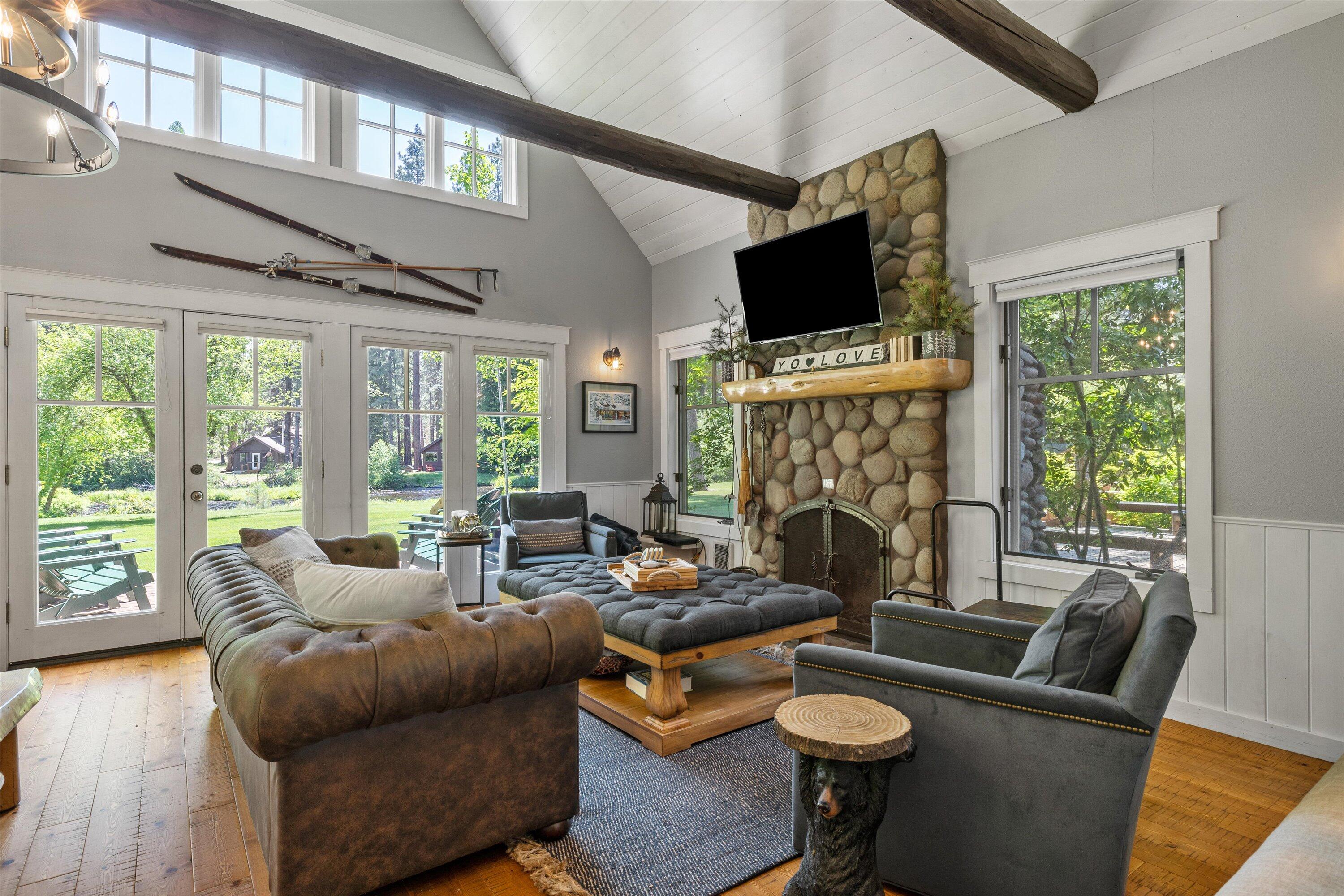 25559 Southwest Suttle-Sherman Road, Unit 5 Camp Sherman, OR 97730 - Photo 5 of 32 Open great room with rock fireplace