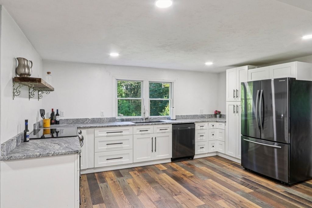 207 Boxboro Road Stow, MA 01775 - Photo 5 of 20 a kitchen with granite countertop a refrigerator stove top oven and sink