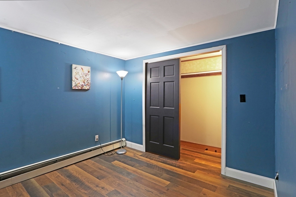 207 Boxboro Road Stow, MA 01775 - Photo 8 of 20 an empty room with wooden floor and closet