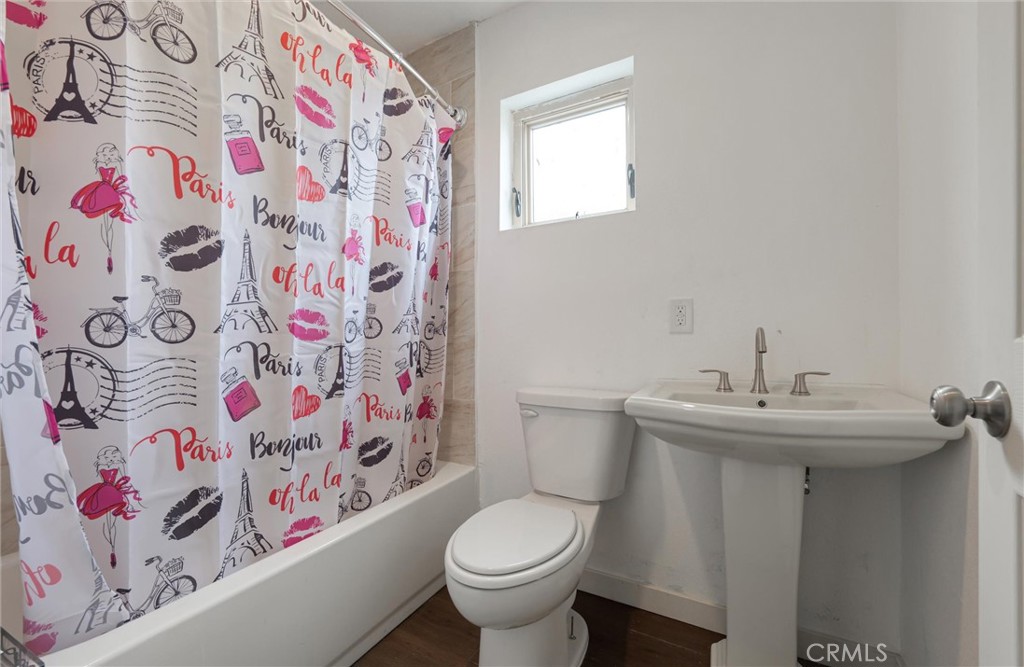 21719 Neptune Avenue Carson, CA 90745 - Photo 11 of 15 a bathroom with a sink and mirror with toilet