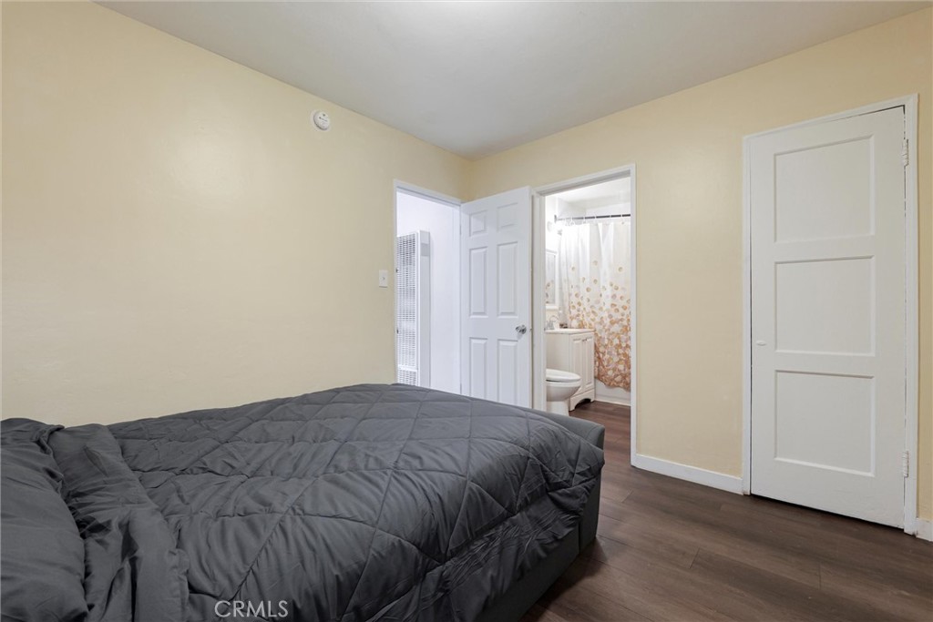 21719 Neptune Avenue Carson, CA 90745 - Photo 13 of 15 a bedroom with a bed and wooden floor