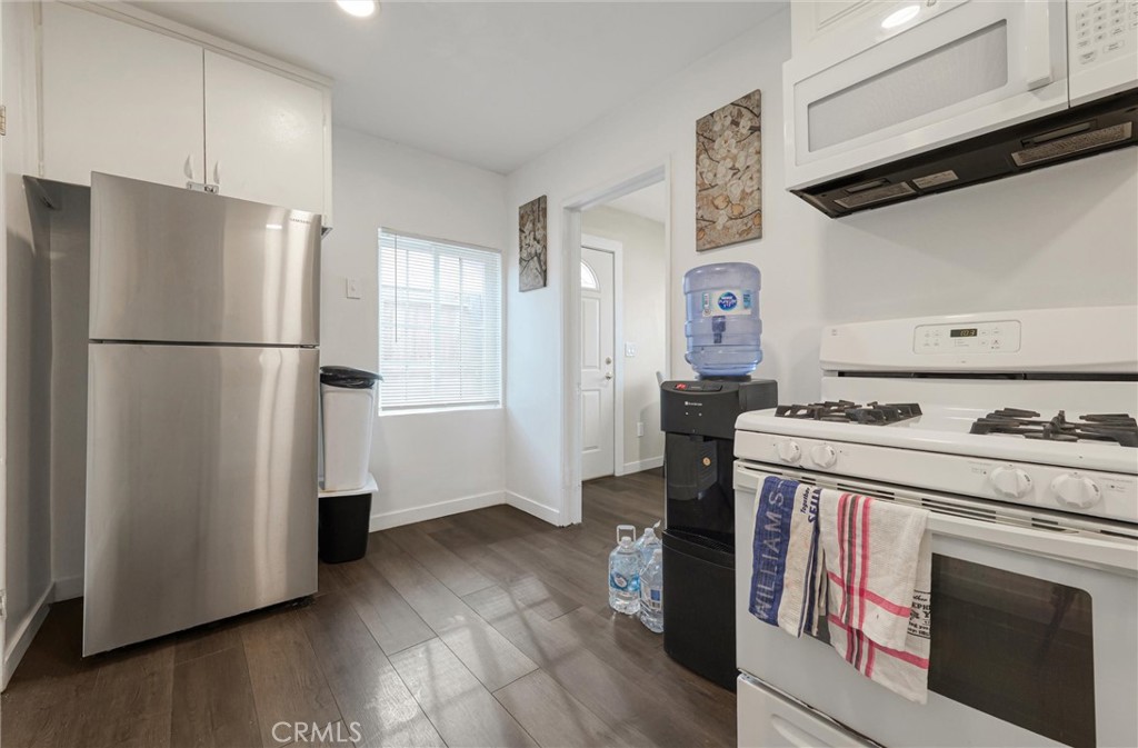 21719 Neptune Avenue Carson, CA 90745 - Photo 7 of 15 a kitchen with a refrigerator and a stove top oven