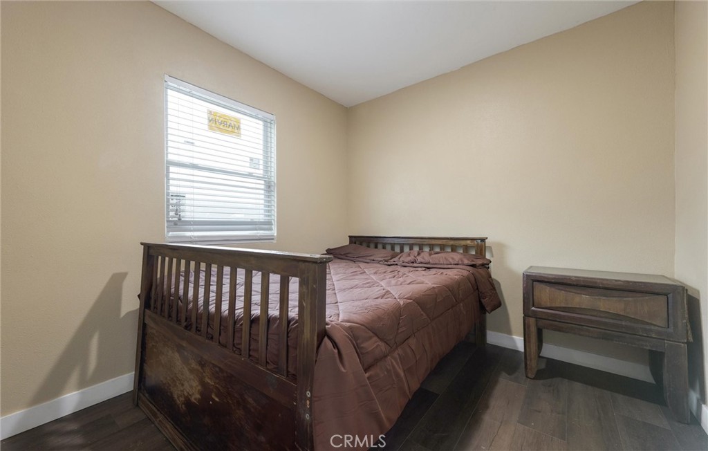 21719 Neptune Avenue Carson, CA 90745 - Photo 9 of 15 a bed sitting in a bedroom next to a window