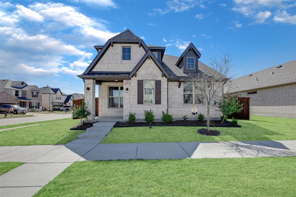 2001 Barx Drive Little Elm, TX 75068 - Photo 1 of 1 View of front of house with stone siding, brick siding, roof with shingles, and a front yard