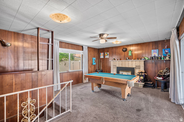 31 B Street Springville, UT 84663 - Photo 13 of 31 Wood paneling throughout, brick fireplace, built-in shelving, white railing, and ceiling fan