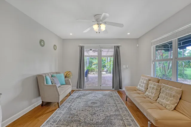 a view of a patio with table and chairs under an umbrella