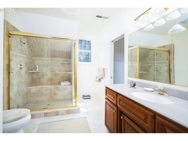 a bathroom with a shower sink and mirror