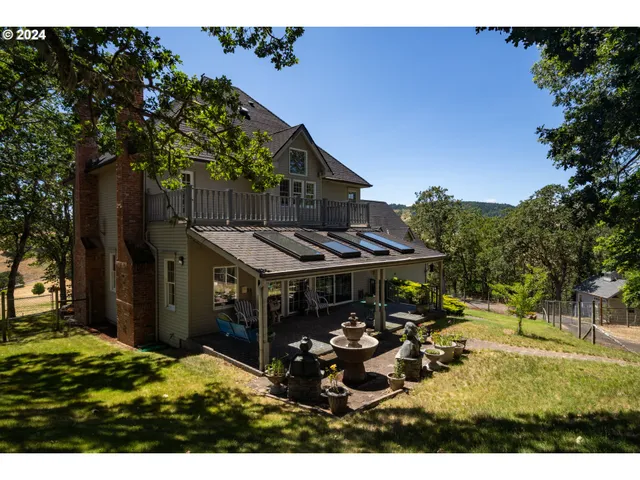 a view of a house with backyard porch and sitting area