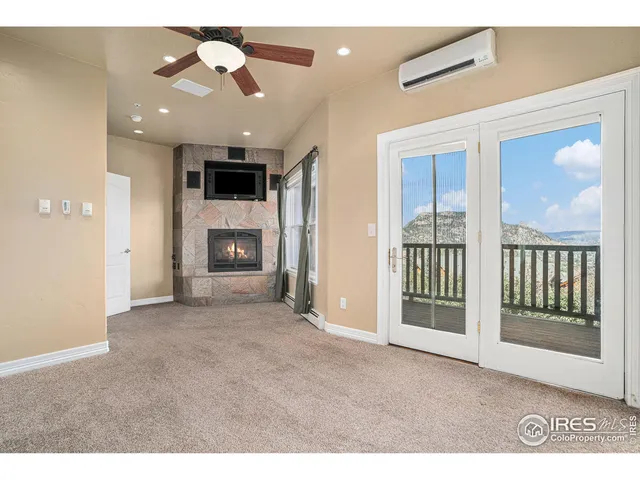 a view of a livingroom with a fireplace and a ceiling fan
