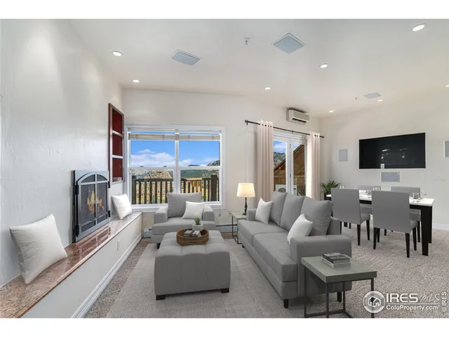 a living room with furniture a flat screen tv and a chandelier