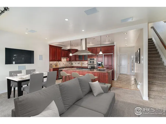 a living room with stainless steel appliances kitchen island granite countertop furniture and a view of kitchen