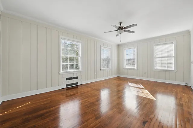 wooden floor in an empty room with a window