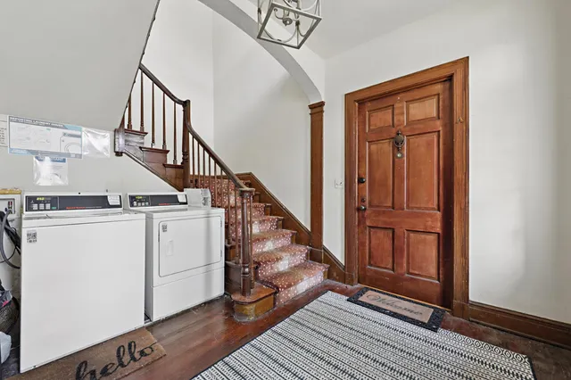 a view of entryway and hall with wooden floor