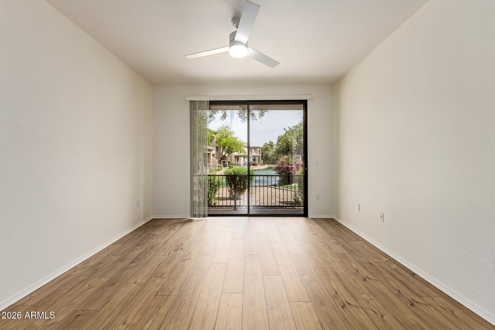 705 West Queen Creek Road, Unit 1167 Chandler, AZ 85248 - Photo 17 of 31 an empty room with wooden floor and windows