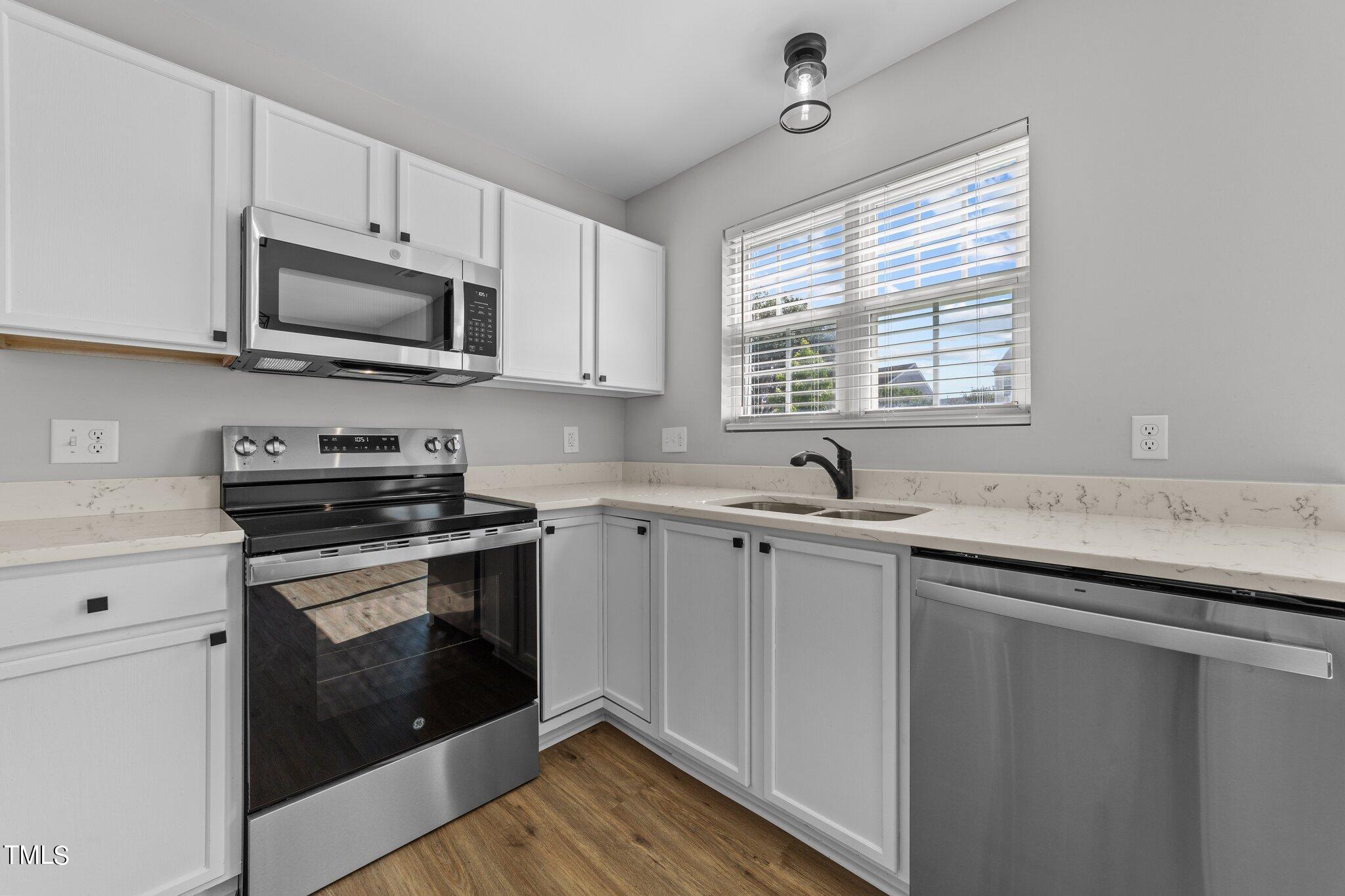 2909 Hayling Drive Raleigh, NC 27610 - Photo 12 of 35 a kitchen with stainless steel appliances granite countertop a sink and a stove