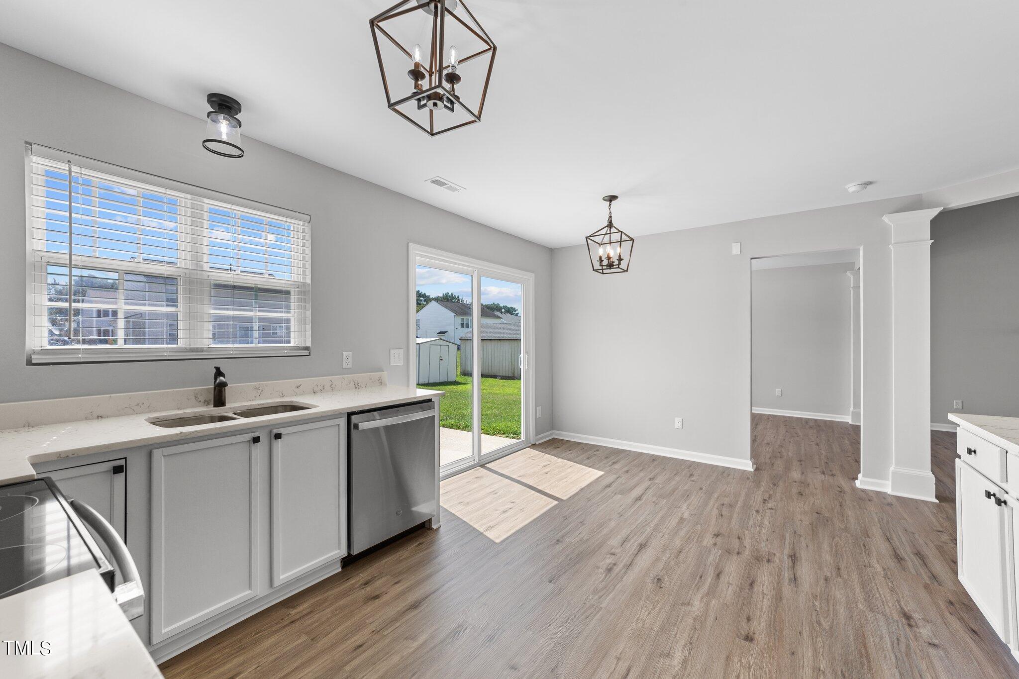 2909 Hayling Drive Raleigh, NC 27610 - Photo 15 of 35 a kitchen with a sink and wooden floor