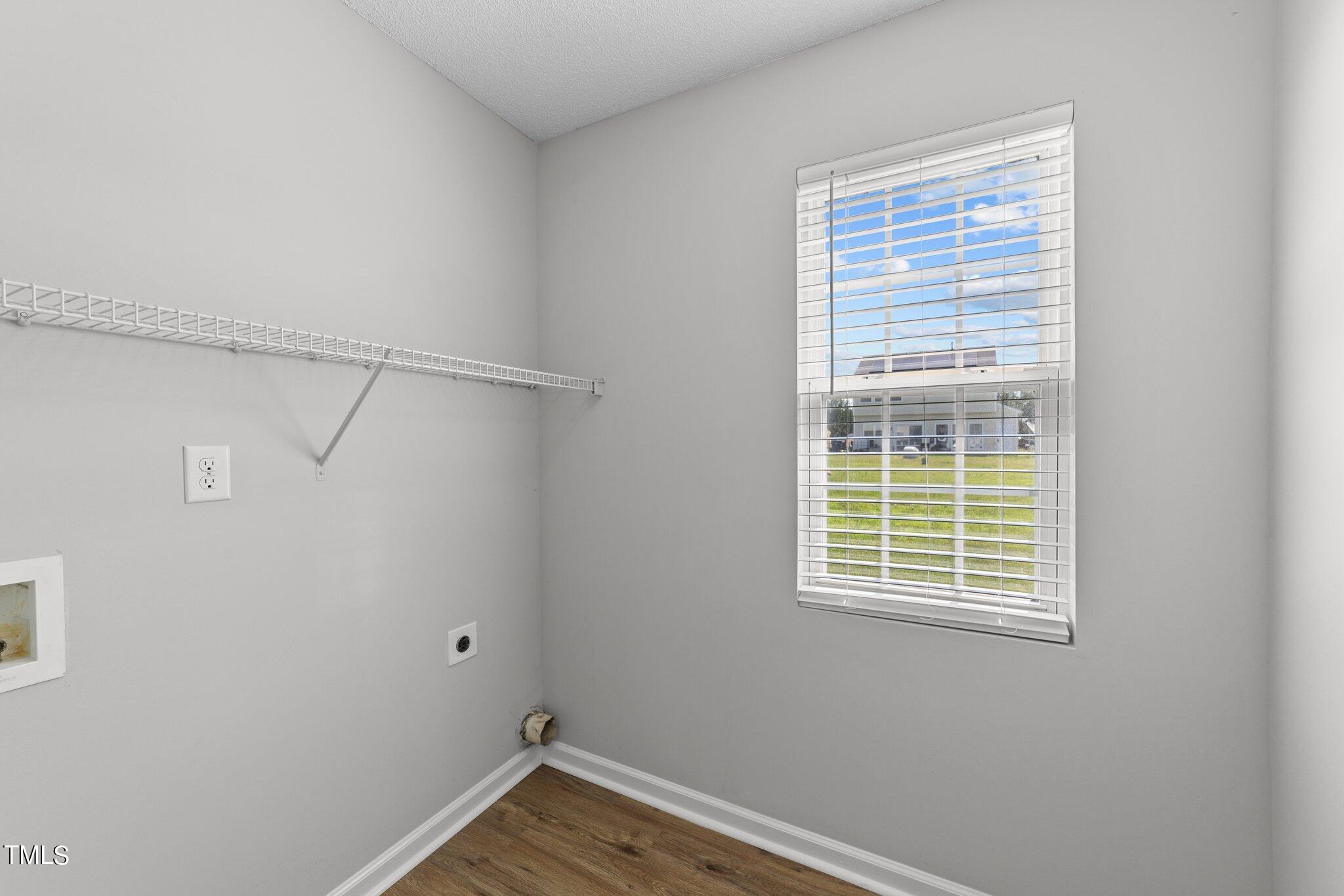 2909 Hayling Drive Raleigh, NC 27610 - Photo 16 of 35 a view of a room with rack on the wall and a window