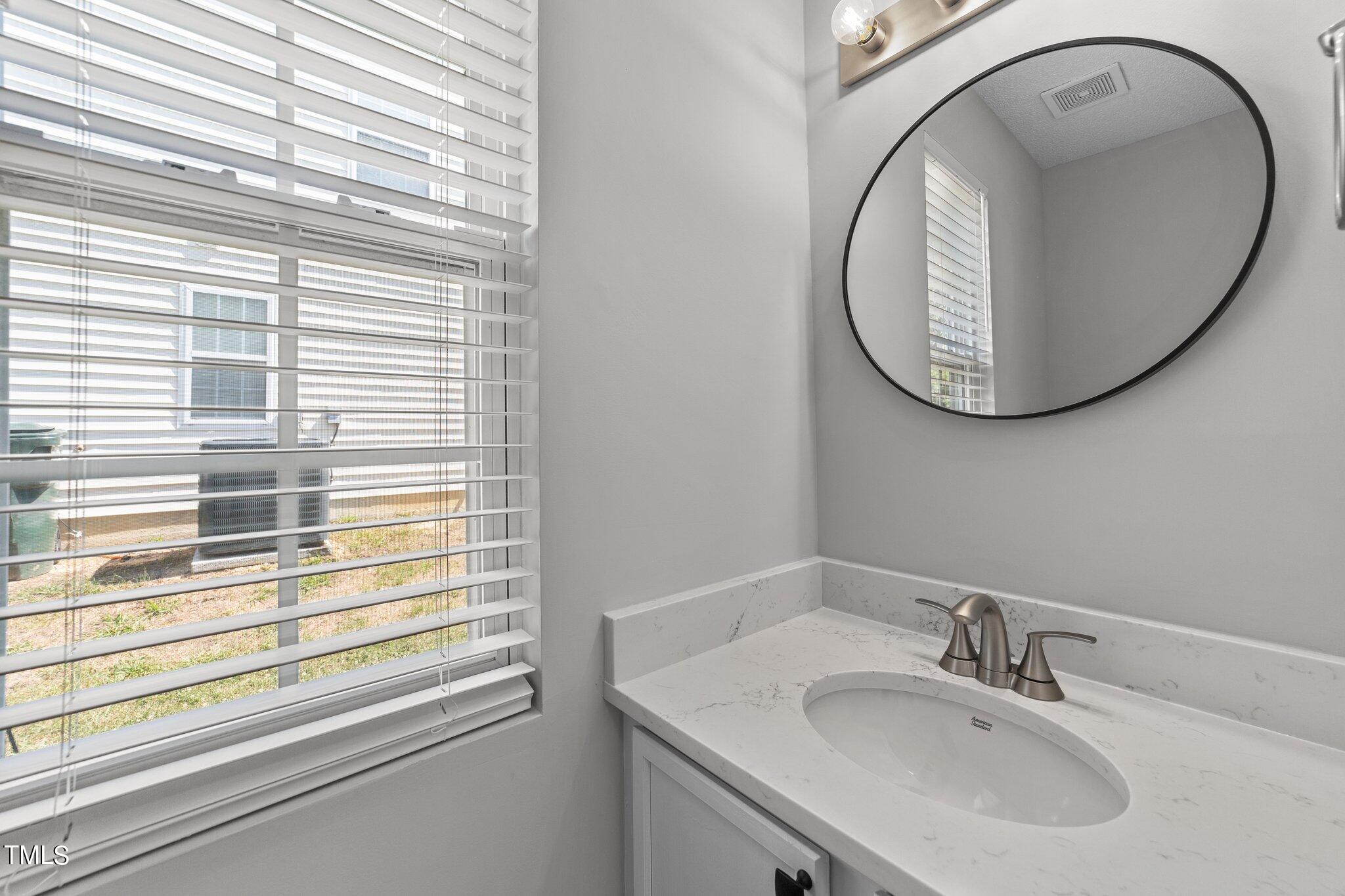 2909 Hayling Drive Raleigh, NC 27610 - Photo 17 of 35 a bathroom with a sink and a mirror