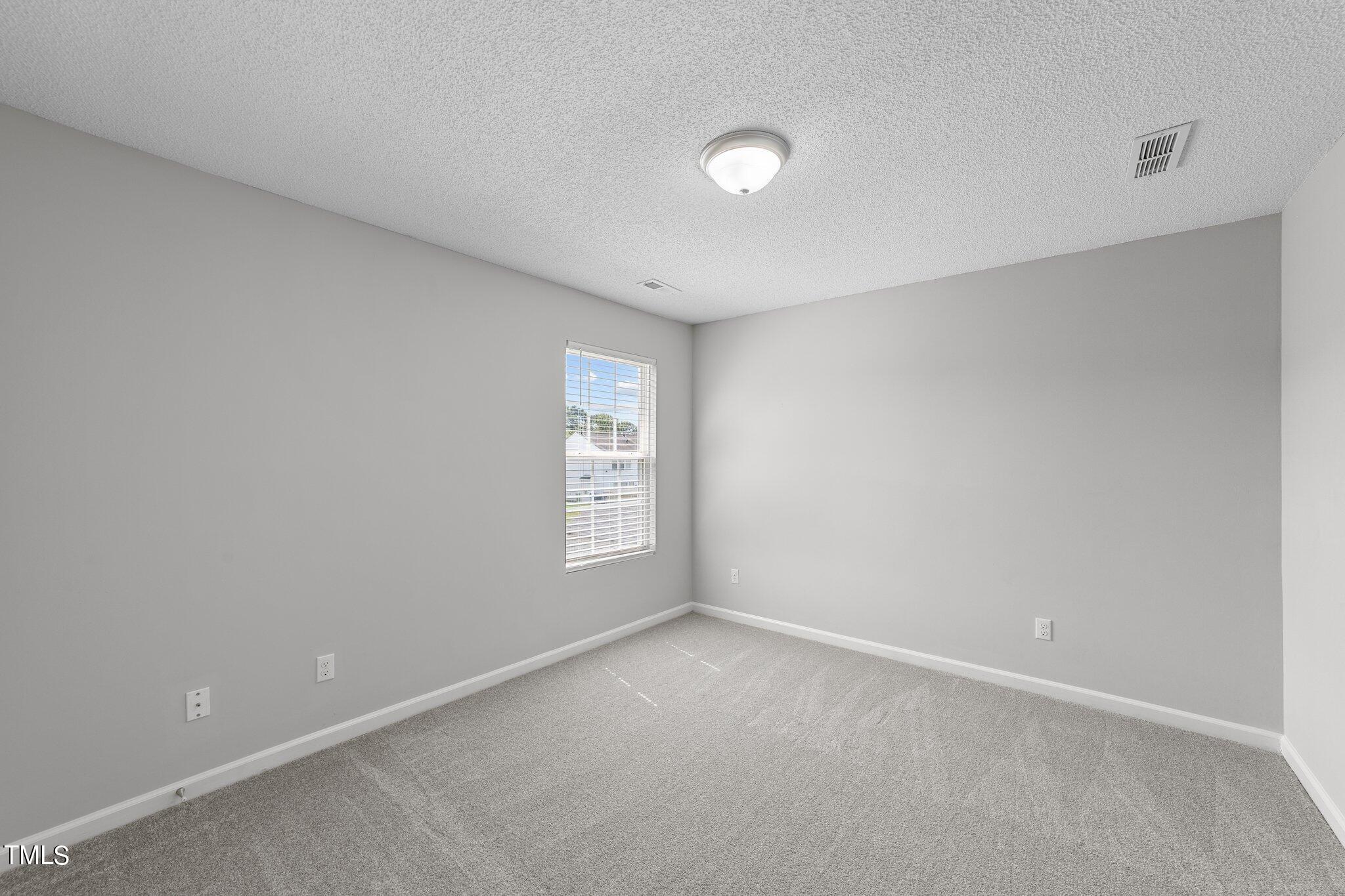 2909 Hayling Drive Raleigh, NC 27610 - Photo 25 of 35 a view of an empty room with a window