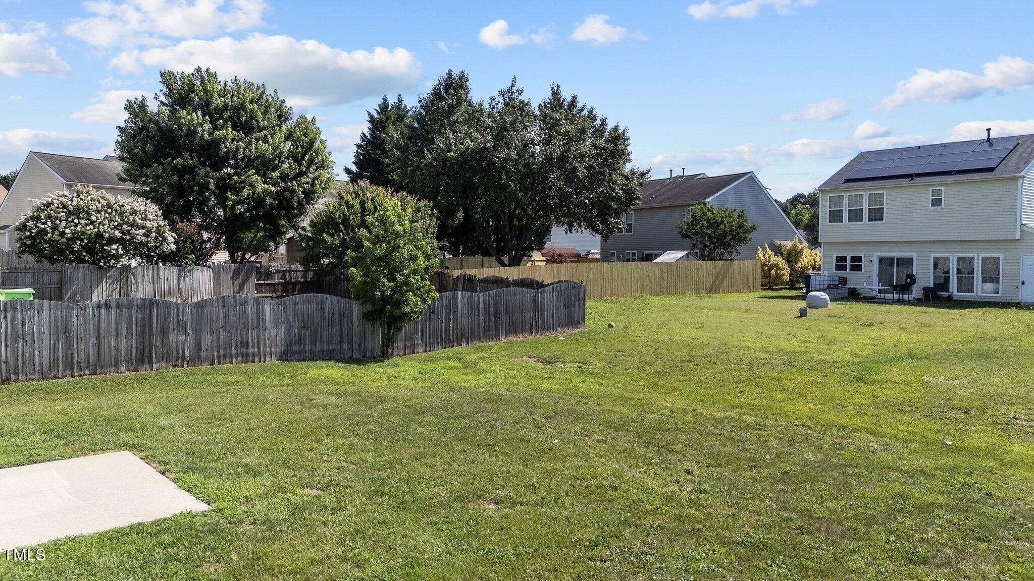 2909 Hayling Drive Raleigh, NC 27610 - Photo 30 of 35 a view of a backyard with a garden and trees