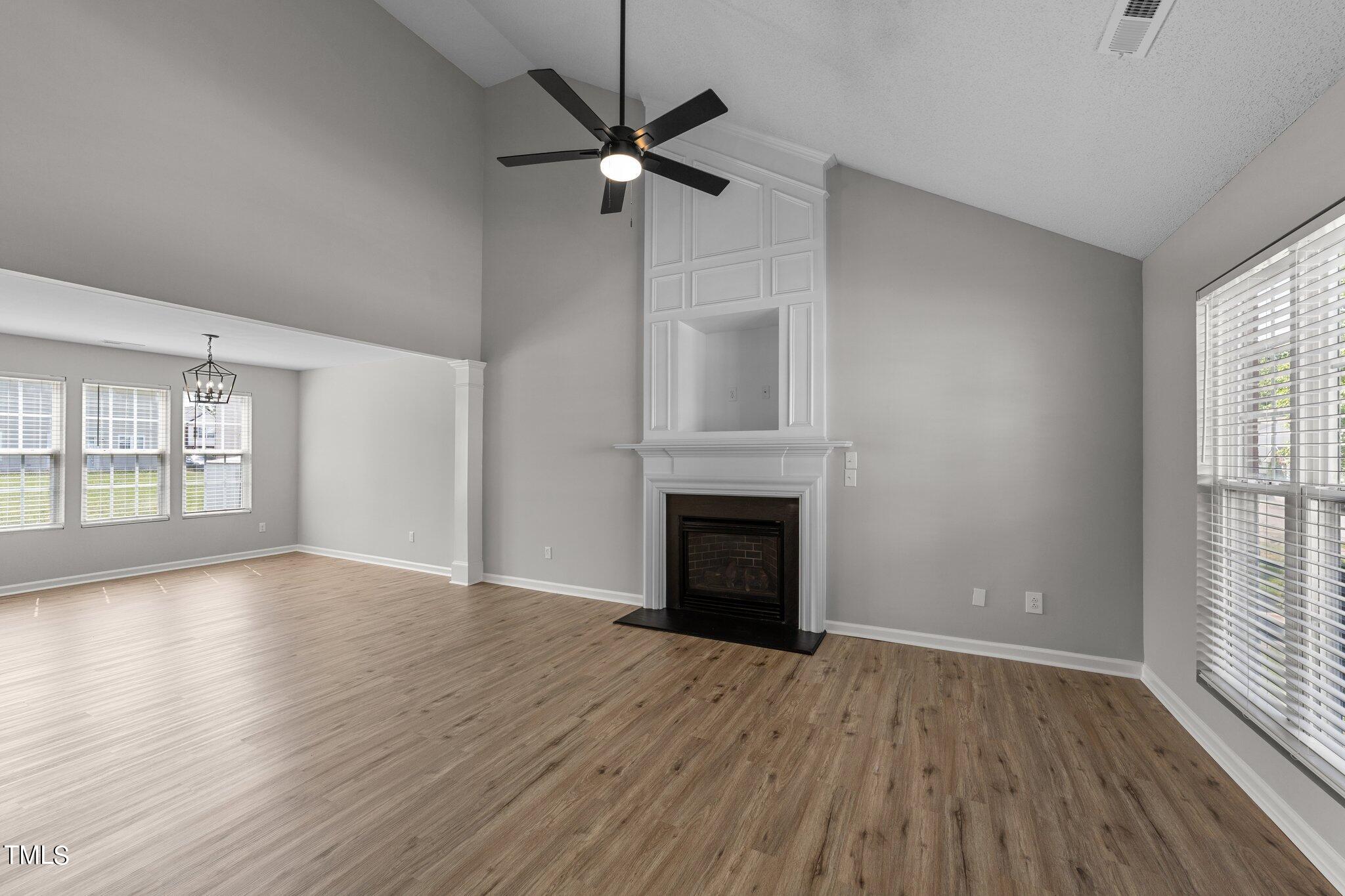 2909 Hayling Drive Raleigh, NC 27610 - Photo 4 of 35 wooden floor fireplace and windows in an empty room