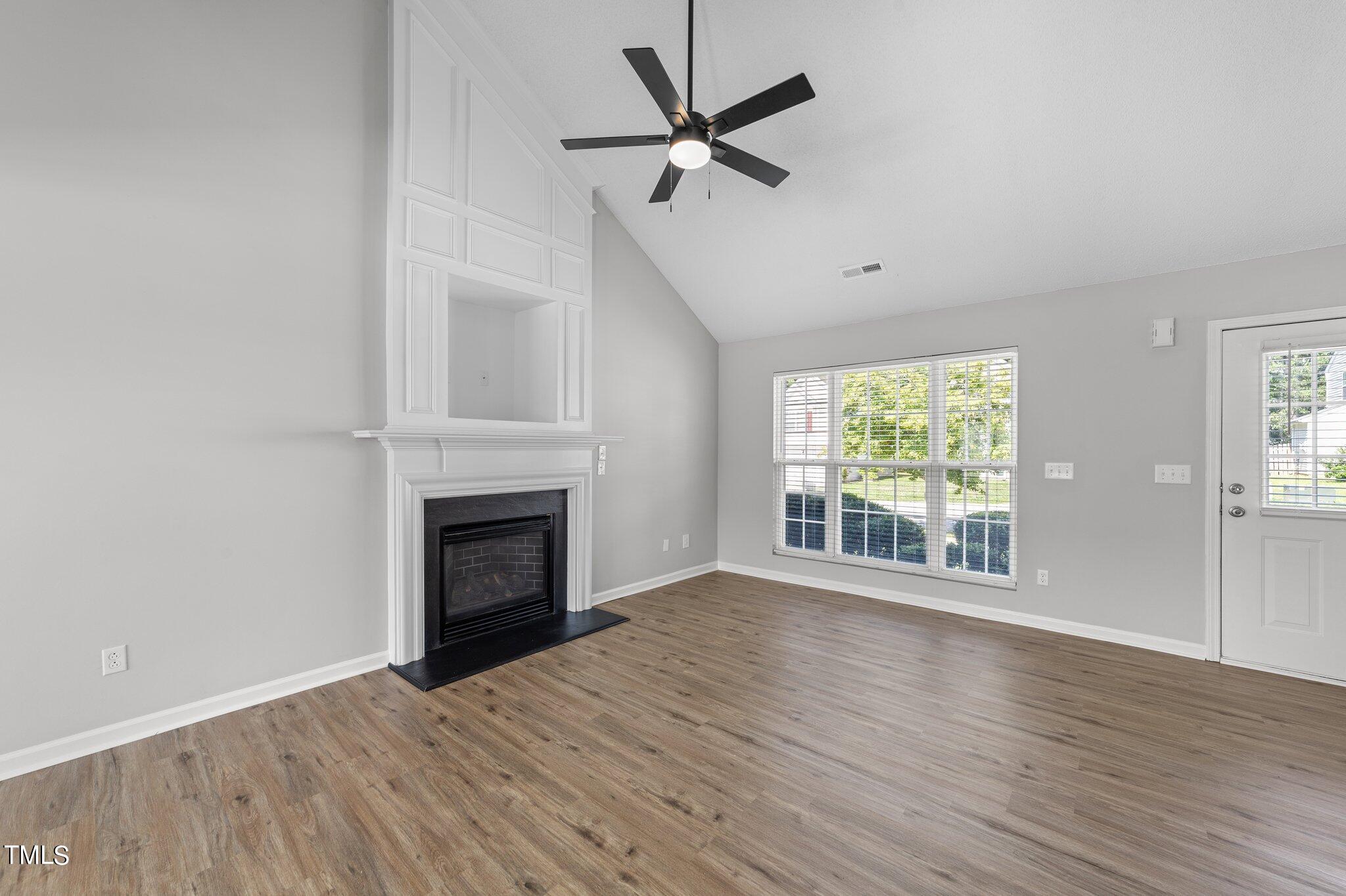 2909 Hayling Drive Raleigh, NC 27610 - Photo 7 of 35 wooden floor fireplace and windows in an empty room