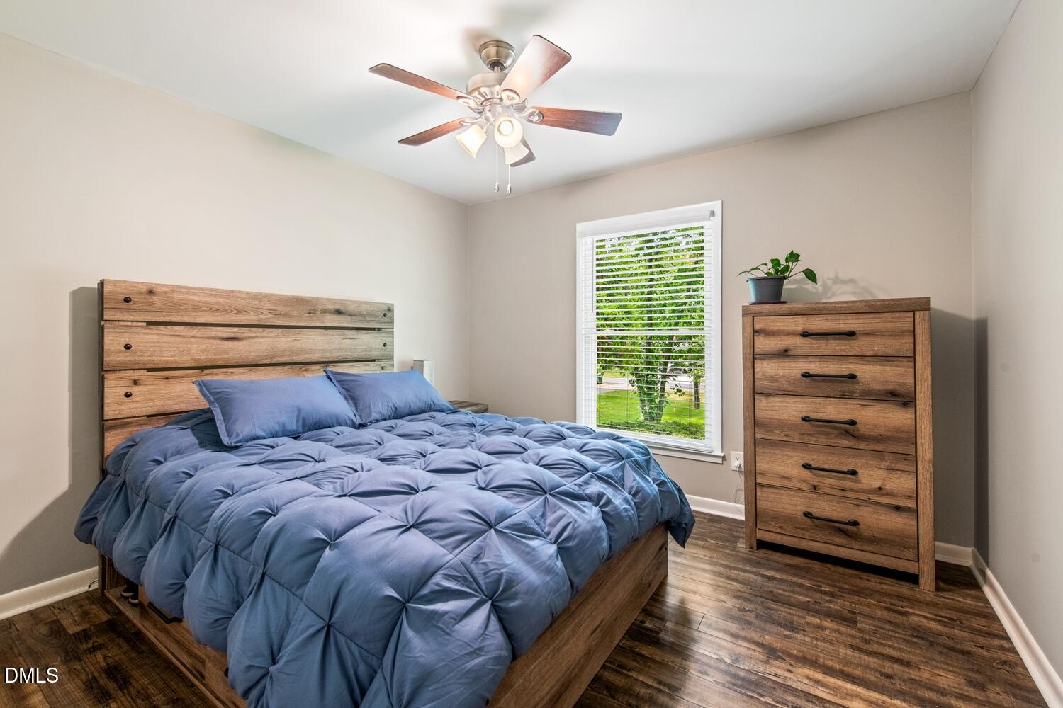 134 Longview Road Madison, NC 27025 - Photo 34 of 49 a bedroom with a bed a chandelier and a window