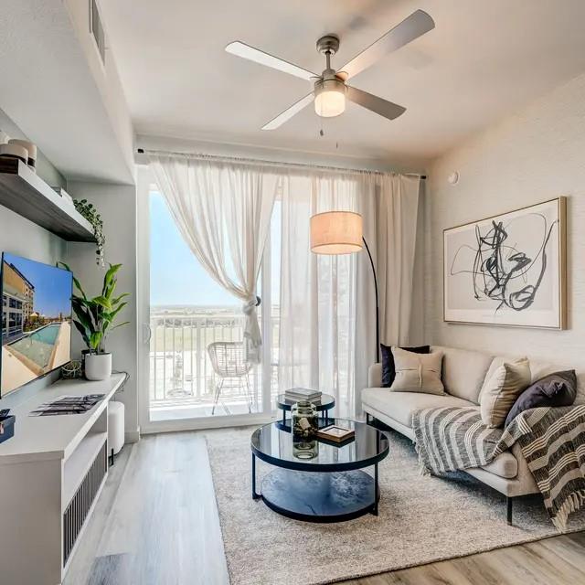 3130 Heritage Trail, Unit 1119 Denton, TX 76201 - Photo 18 of 39 Living area featuring light wood-style floors and a ceiling fan