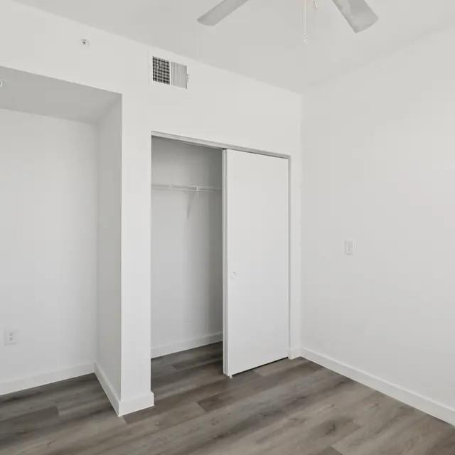 3130 Heritage Trail, Unit 1119 Denton, TX 76201 - Photo 23 of 39 Unfurnished bedroom featuring dark wood-style floors, a closet, and ceiling fan