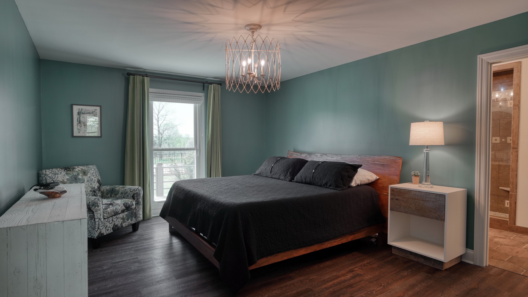 560 Big Spring Hollow Road Pulaski, TN 38478 - Photo 12 of 41 a bedroom with a bed and a chandelier
