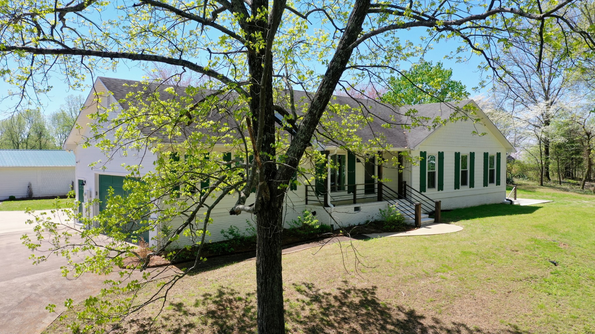 560 Big Spring Hollow Road Pulaski, TN 38478 - Photo 2 of 41 a view of house in front of a yard with potted plants and large trees