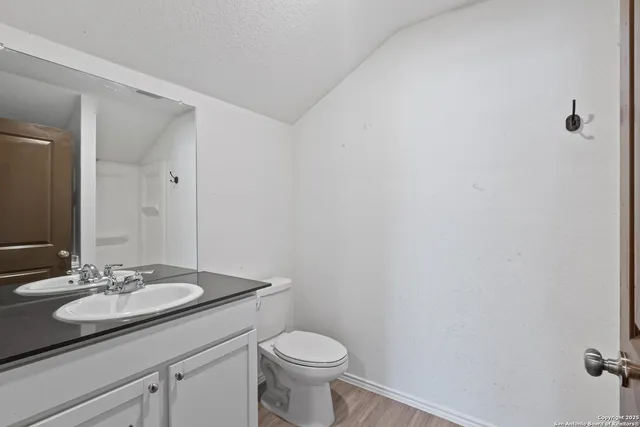 a bathroom with a sink toilet and a mirror