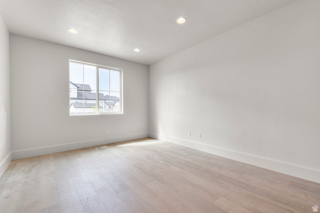 11718 South Halls Crk Road Draper, UT 84020 - Photo 10 of 28 Bright interior space featuring a large multi-pane window, recessed lighting, light wood-finish flooring, and white trim throughout