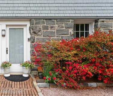 a front view of house with flowers