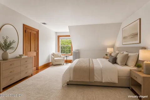 a bedroom with a large bed and a window