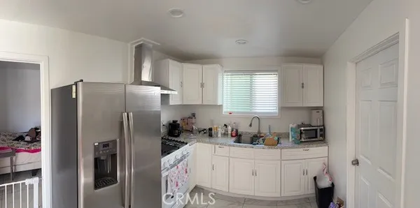 a kitchen with stainless steel appliances a refrigerator sink and cabinets