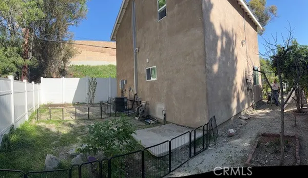 a wooden bench sitting in backside of a house