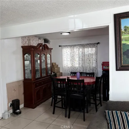 a view of a dining room with furniture and window